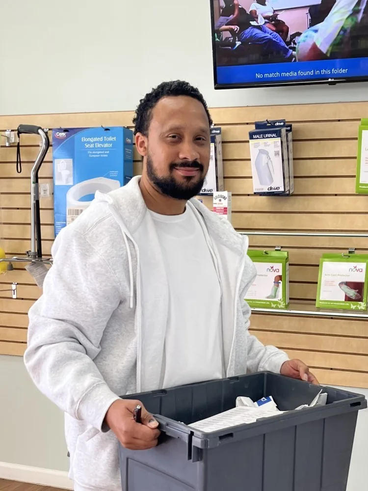 Team member carrying a delivery tote